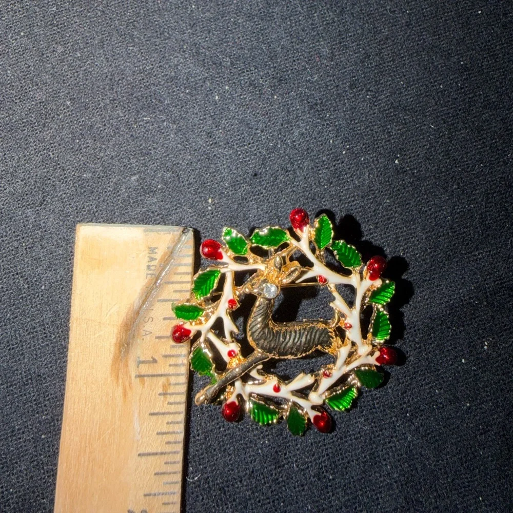 Elegant Gold Reindeer Brooch with Green and Red Accents
